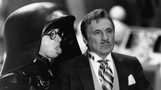Spaceballs, Darth helmet (Rick Moranis) with his mask up sticking his tongue out at Spaceball President Skroob (Mel Brooks).